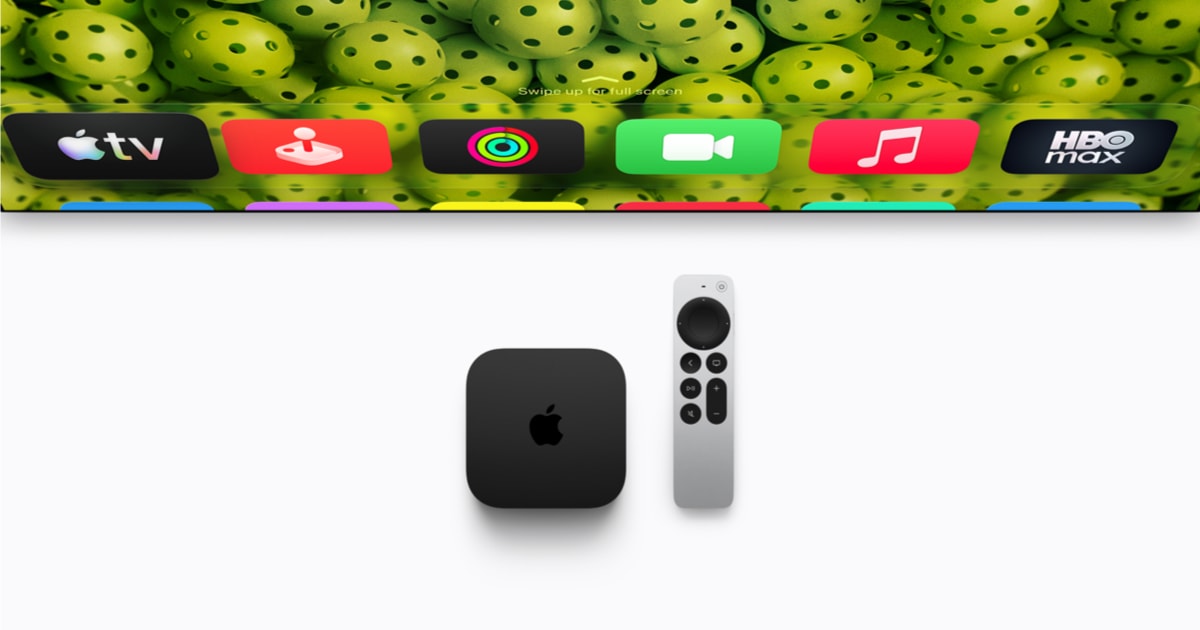Apple TV 4K and Siri Remote beneath a television showing the tvOS home screen.