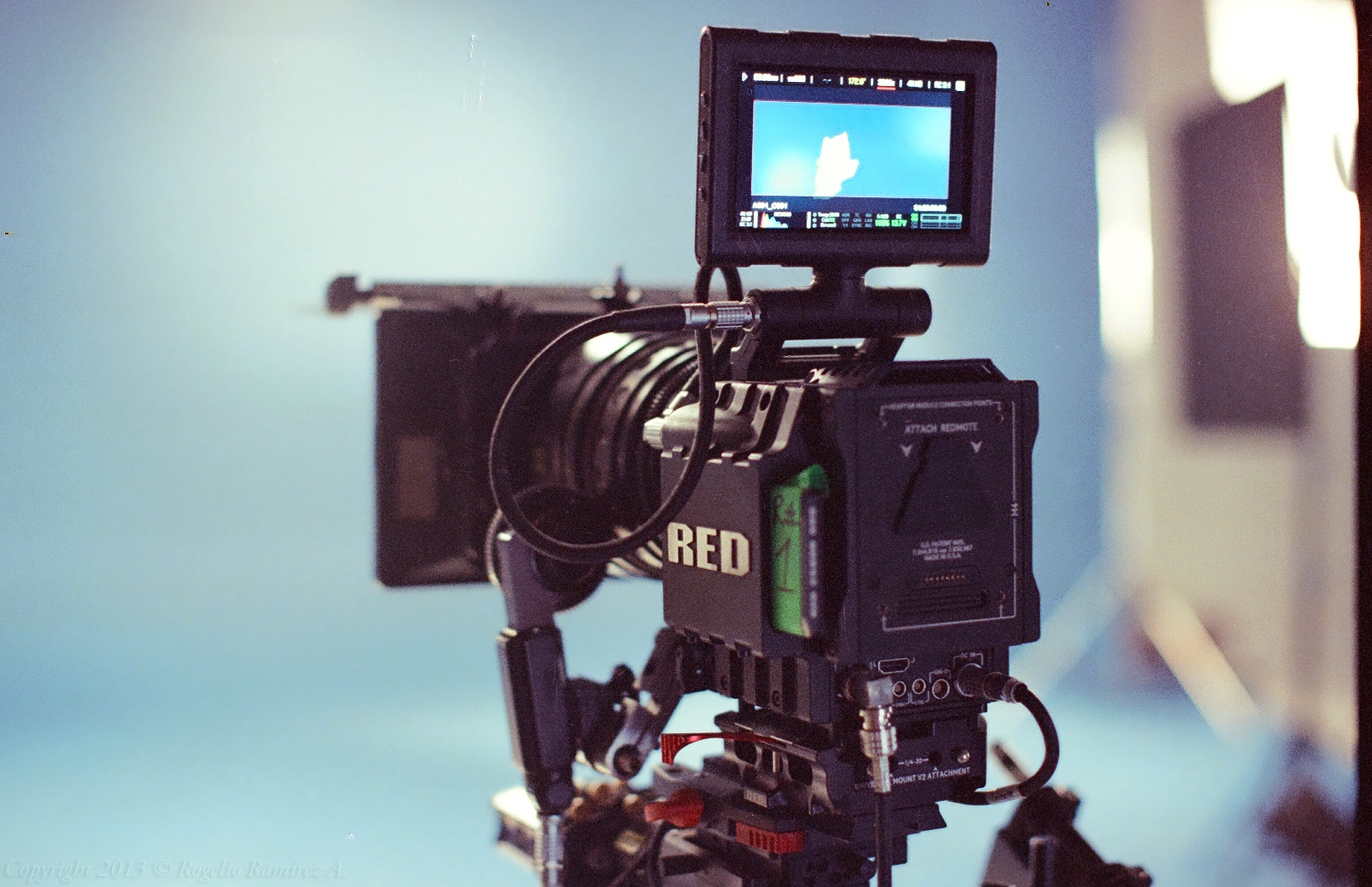A RED EPIC cinema camera with a lens and viewfinder, rigged for a film shoot.