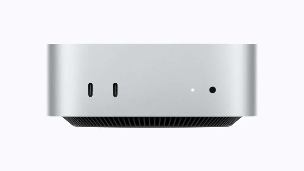 Front view of a silver Apple Mac mini, with two USB-C ports, a status light and a headphone jack.