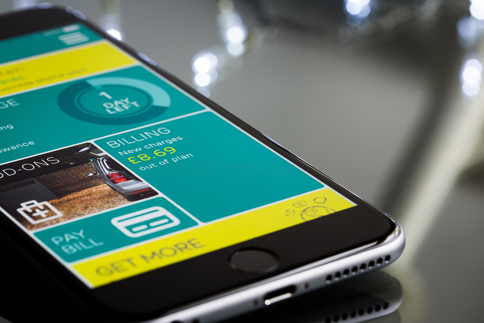 A person holding a smartphone open to a mobile banking screen.