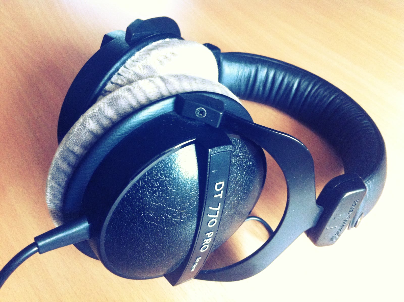 Black over-ear studio headphones on a dark surface.
