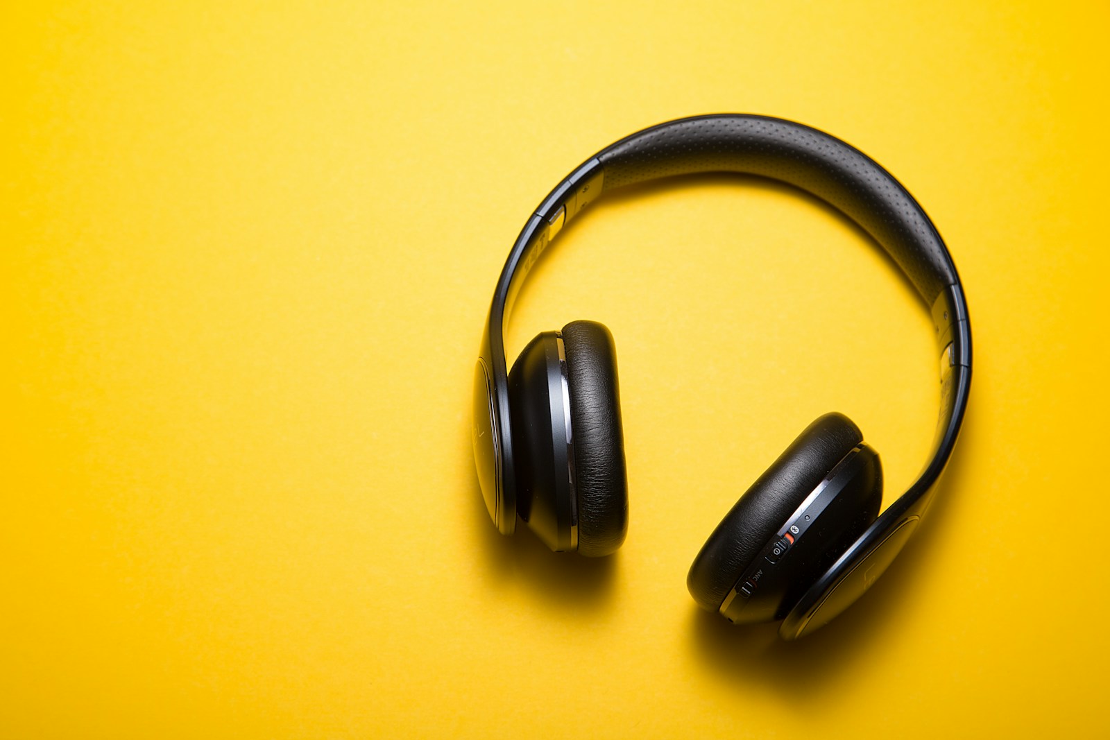 Red over-ear headphones on a colored background