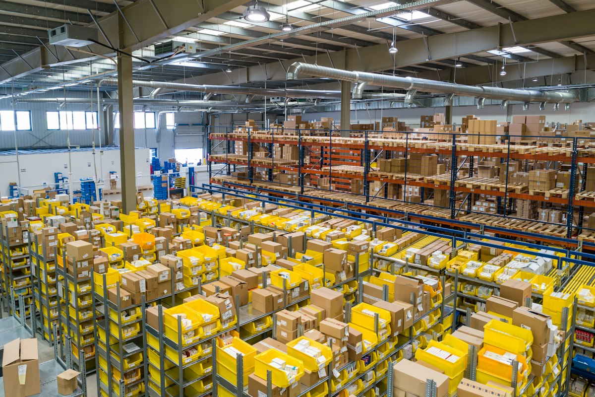 Stacked shipping boxes in a warehouse aisle