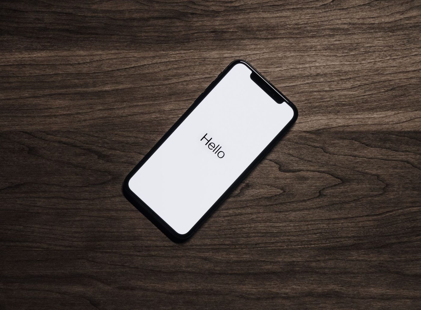 Person holding a smartphone with the screen illuminated