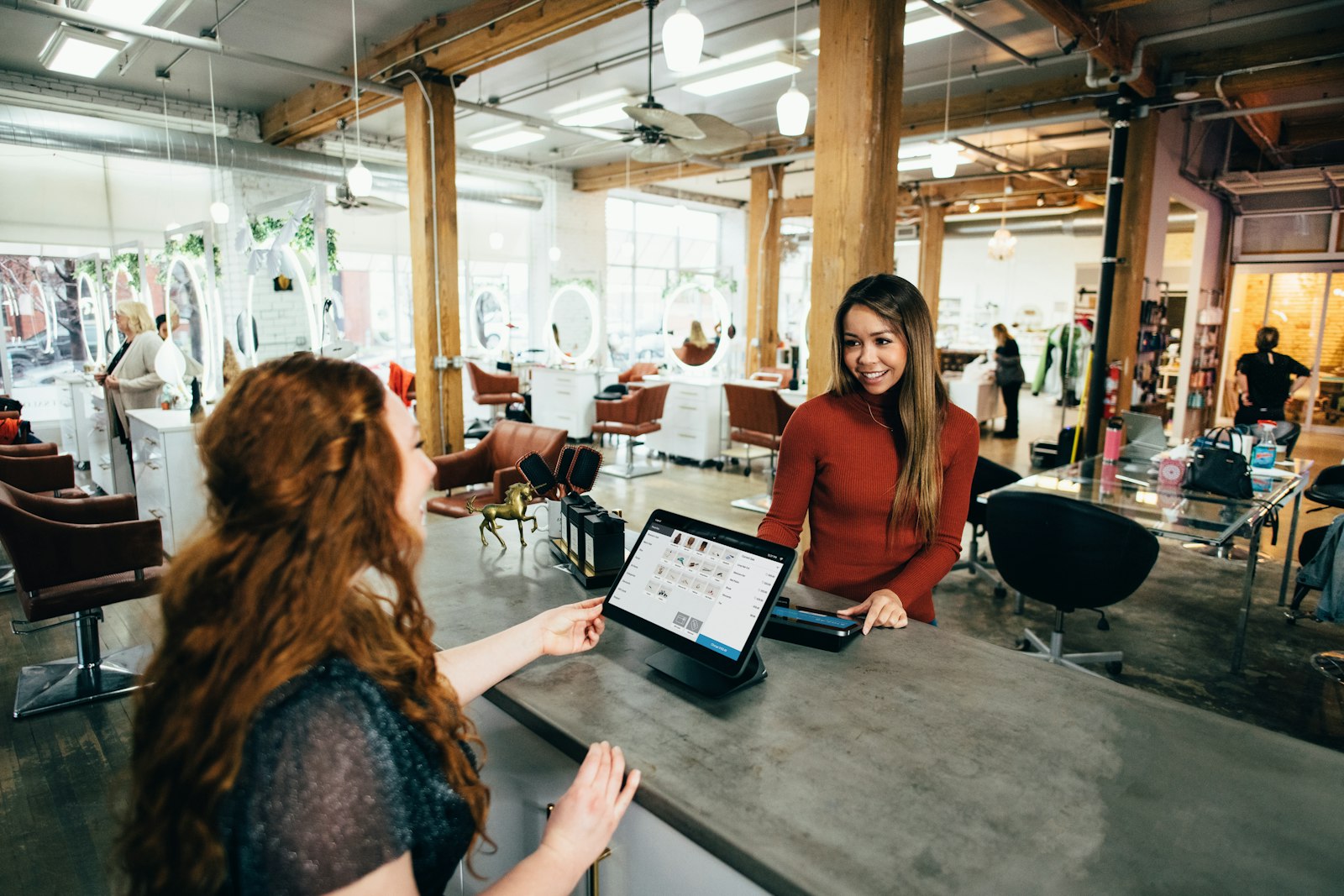 Customer paying at a modern tablet point-of-sale counter