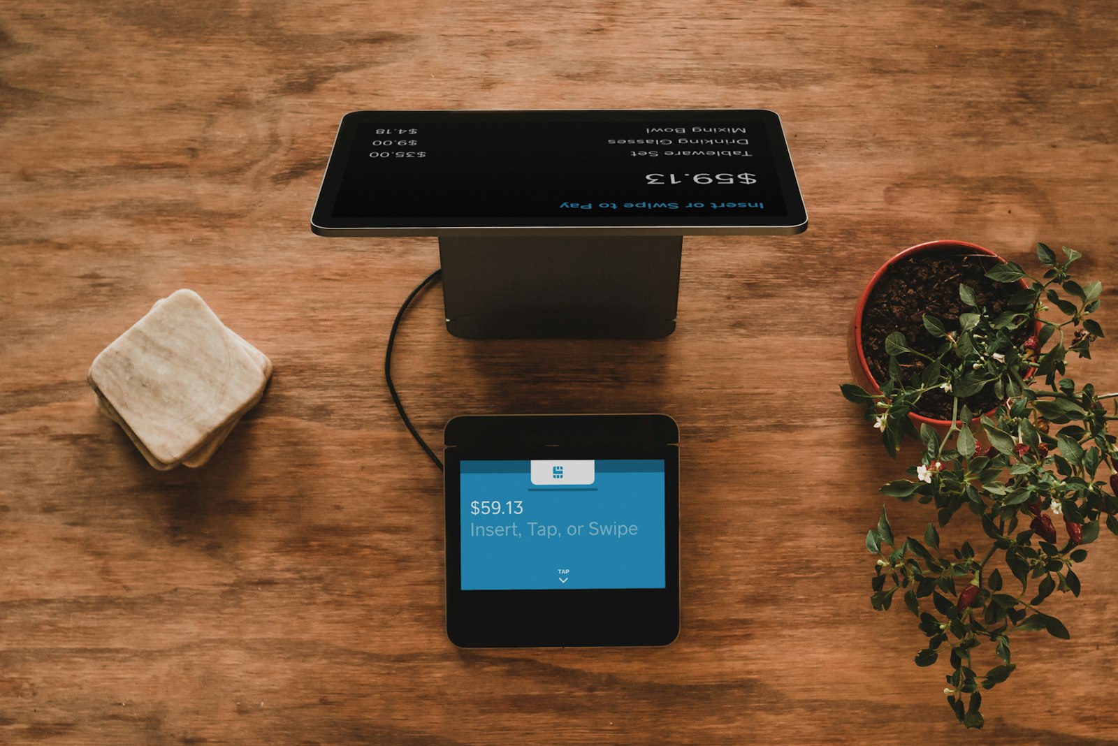 Customer paying with a card at a cafe counter