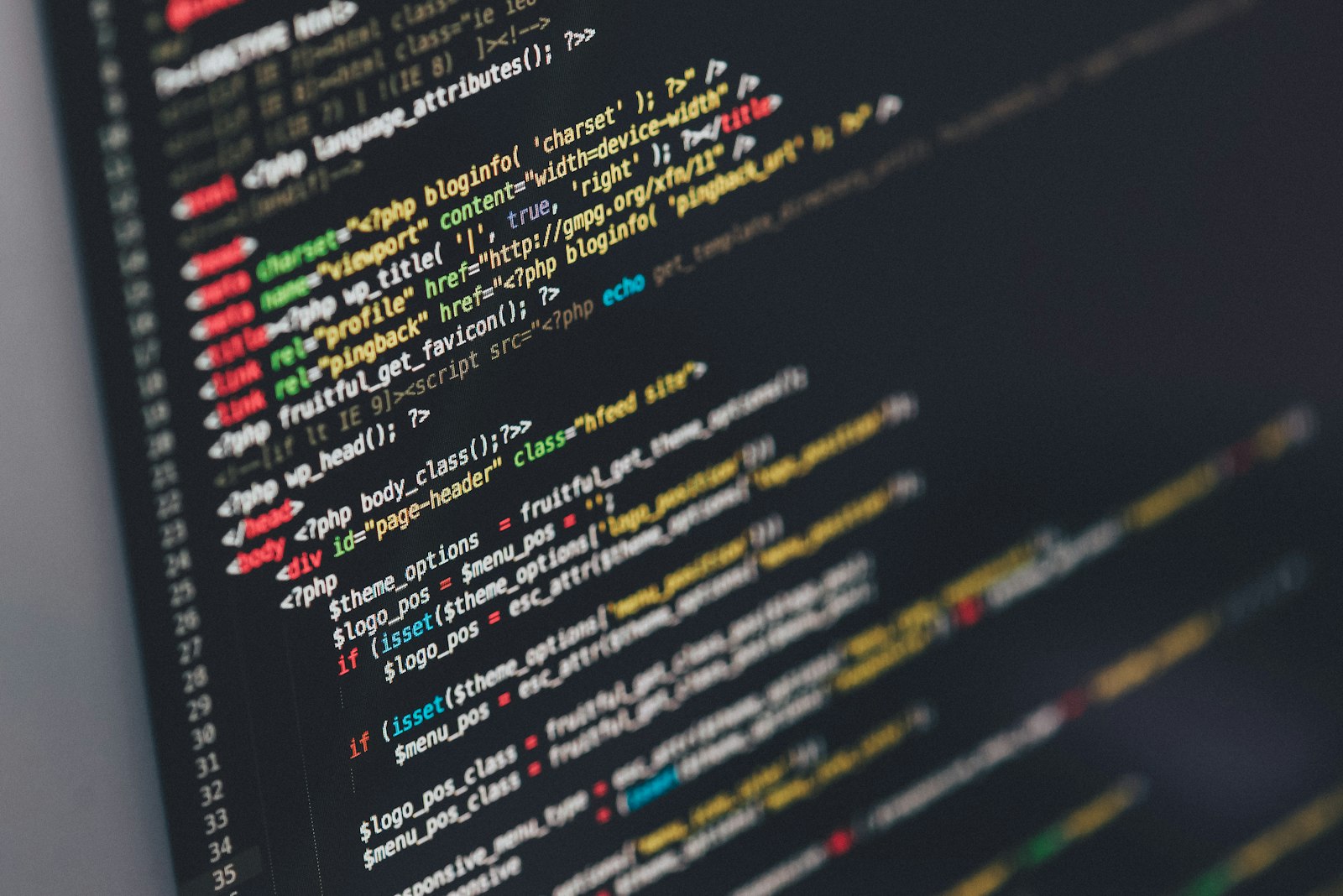 Laptop screen showing HTML and CSS code in a dark editor