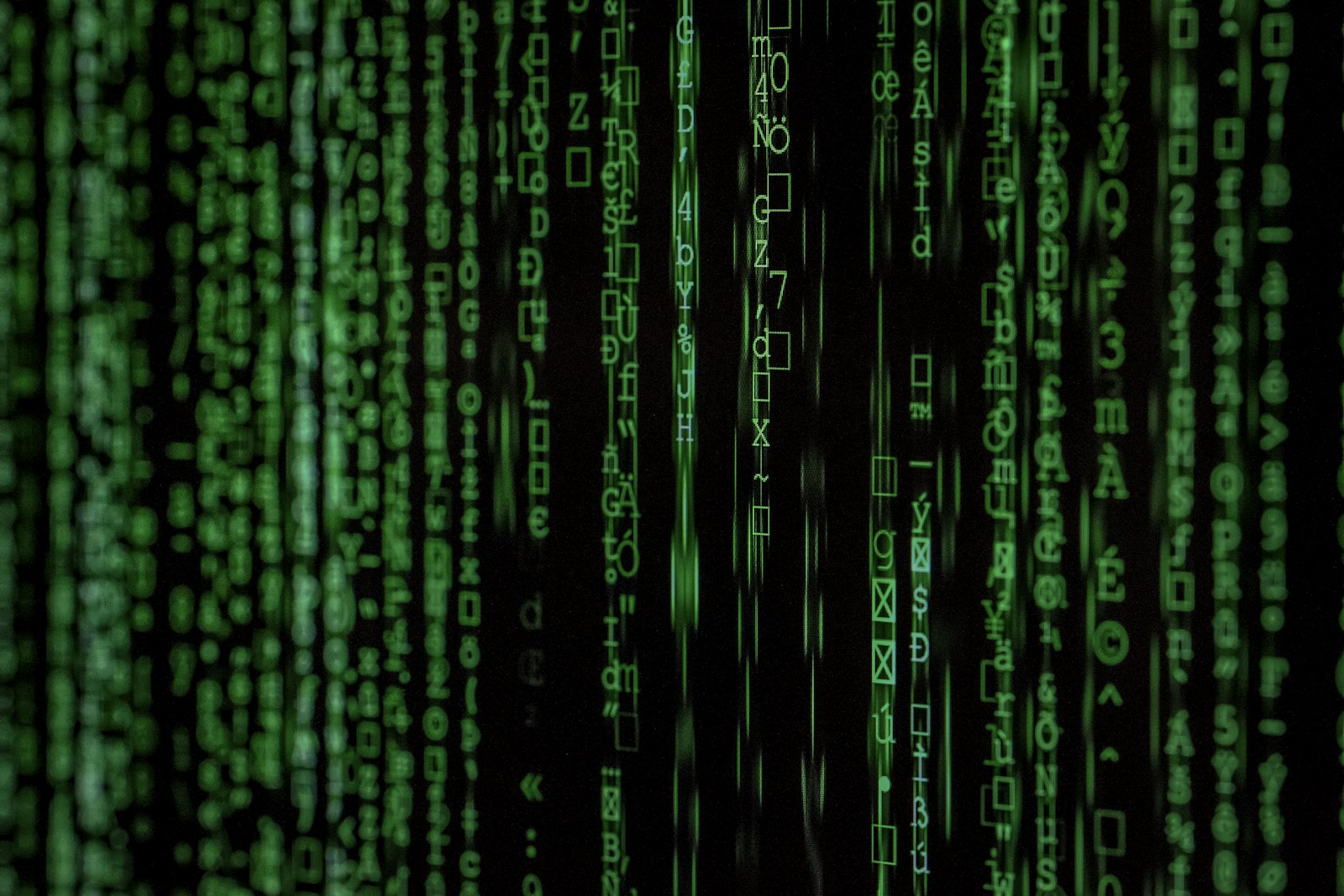 Matrix-style digital code on a dark screen, cyber geek mood