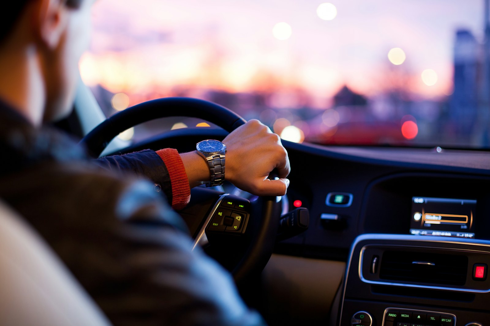 Car dashboard and steering wheel on the road