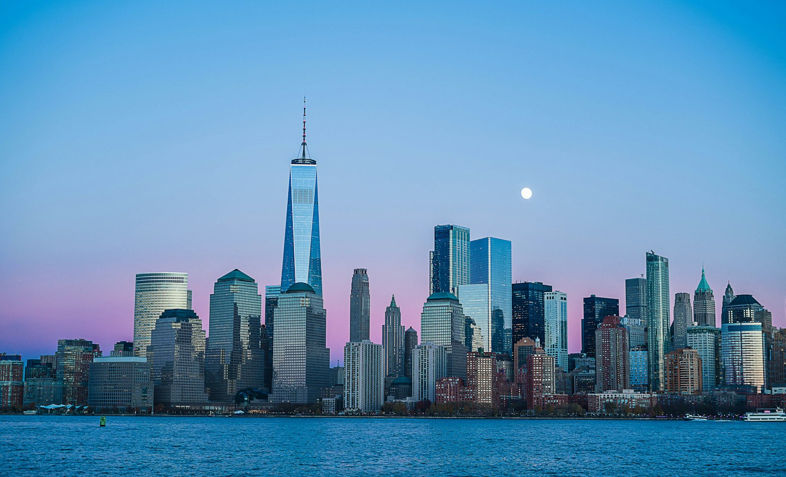 City skyline glowing at night with lit windows across high-rise buildings
