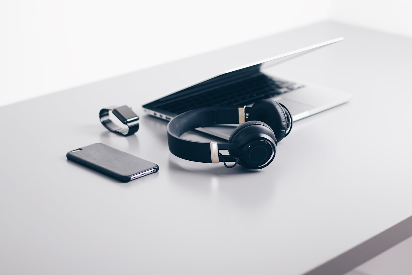 Assorted consumer gadgets and devices arranged on a clean desk