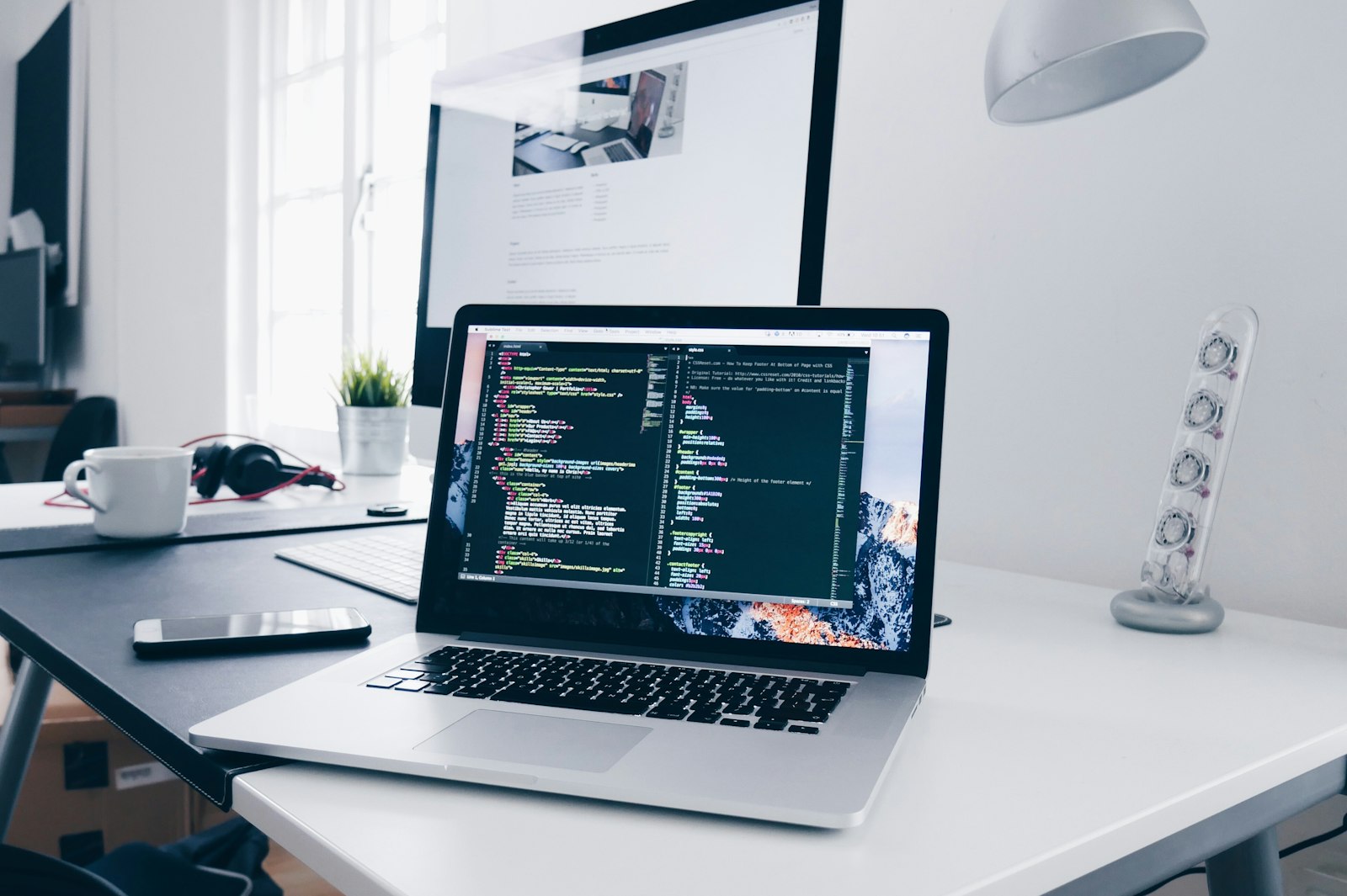 Laptop and coffee on a wooden desk workspace