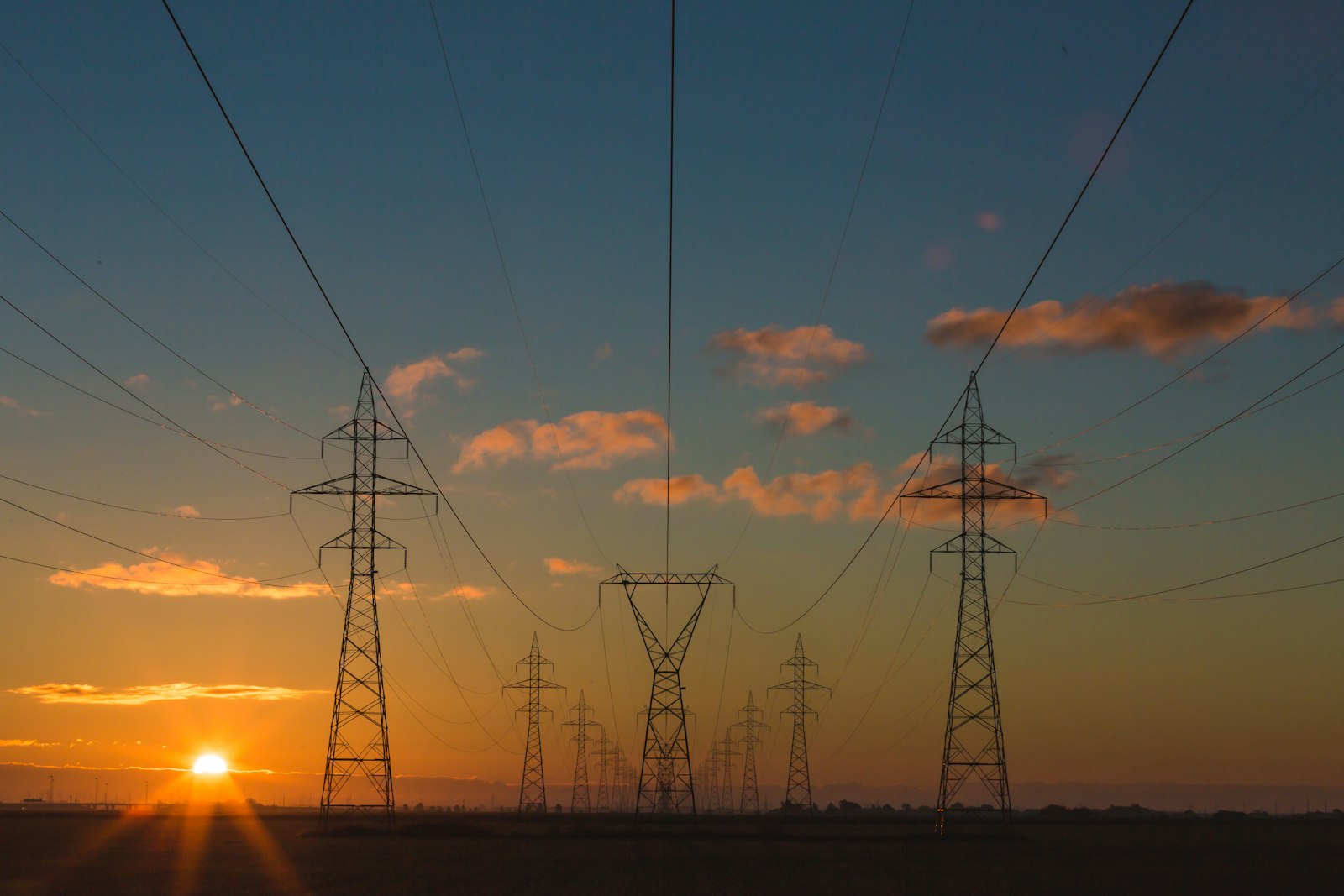 High-voltage power lines against a dramatic sky