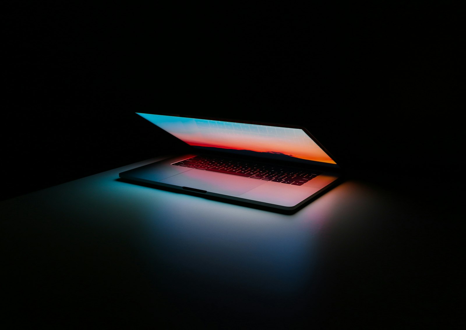 Slim silver laptop open on a wooden desk