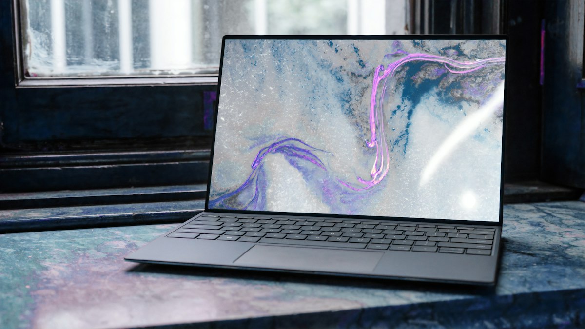 Modern laptop keyboard and screen on a desk