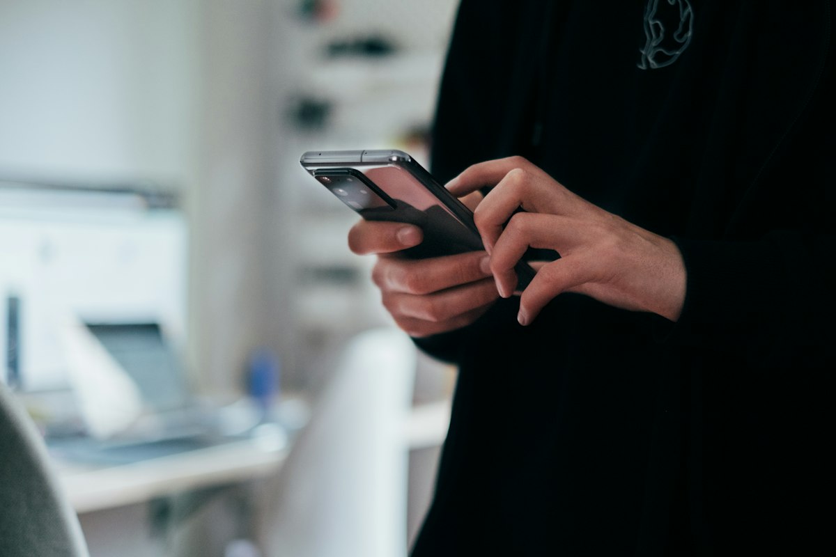 Person holding a modern smartphone outdoors