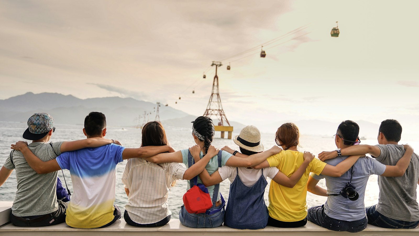 Friends laughing together outdoors at dusk