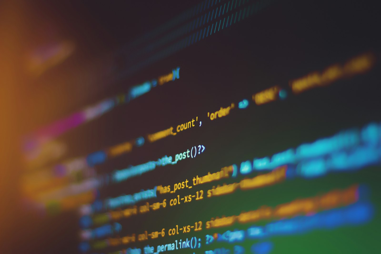 Laptop screen showing code and terminal windows on a desk