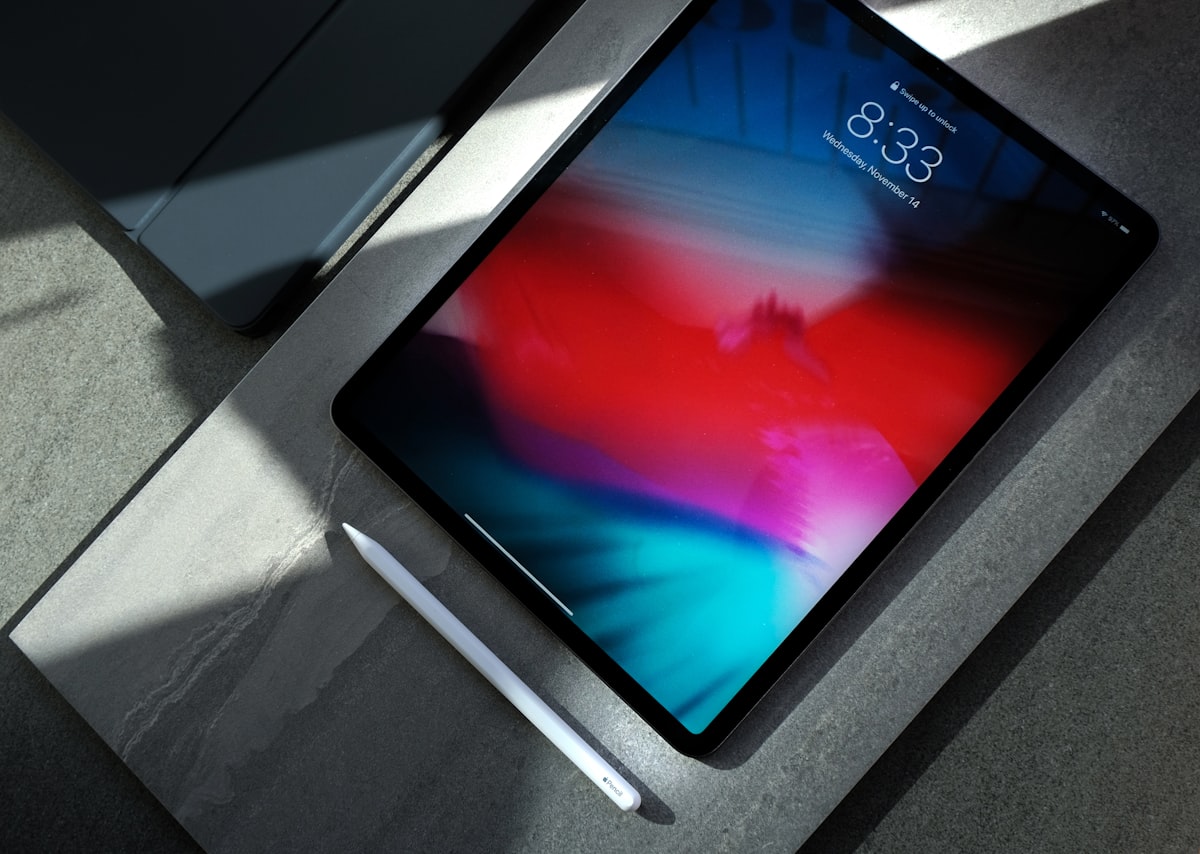Tablet-style device held open for reading