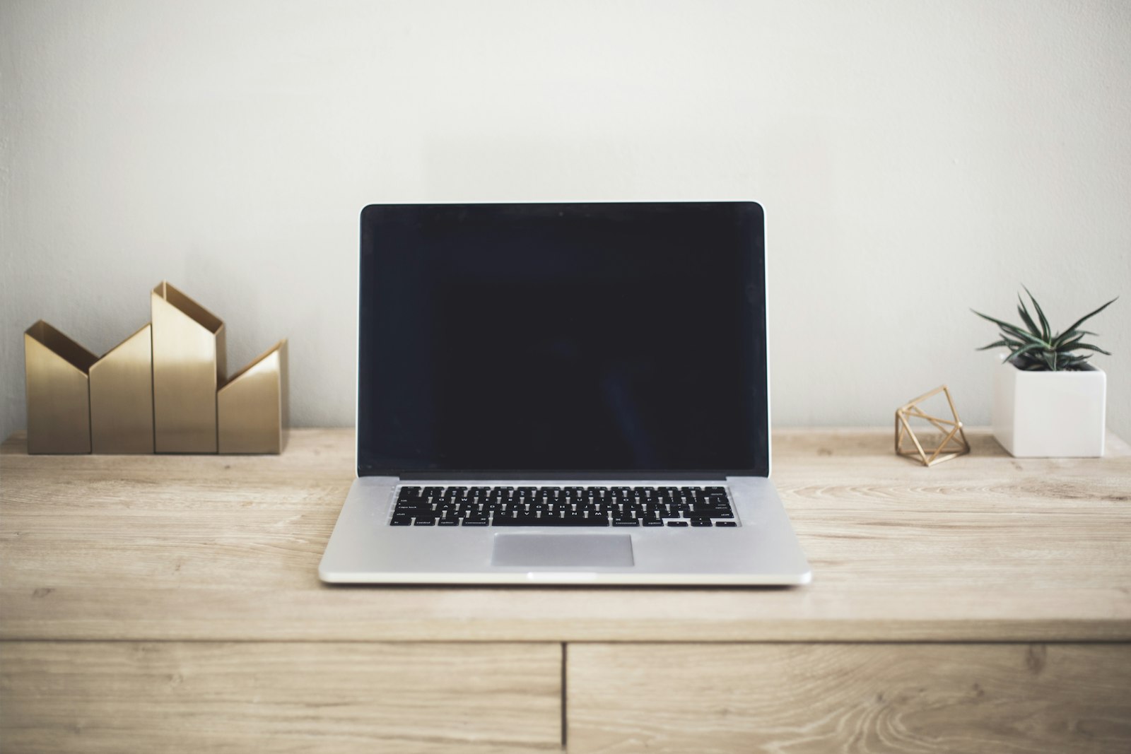 Laptop computer open on a desk with coffee