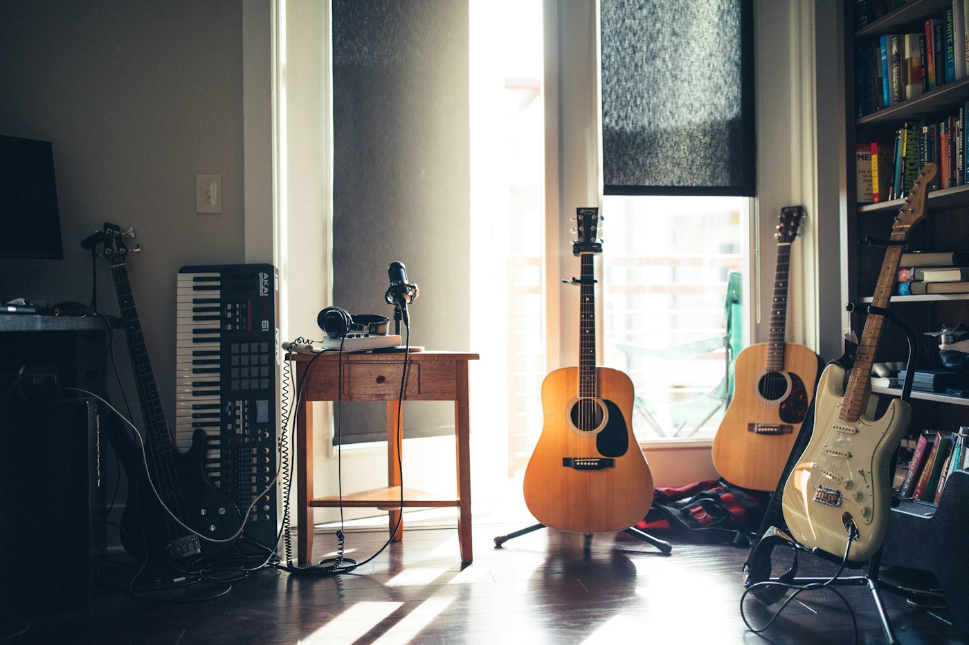 Music production desk with headphones and studio gear
