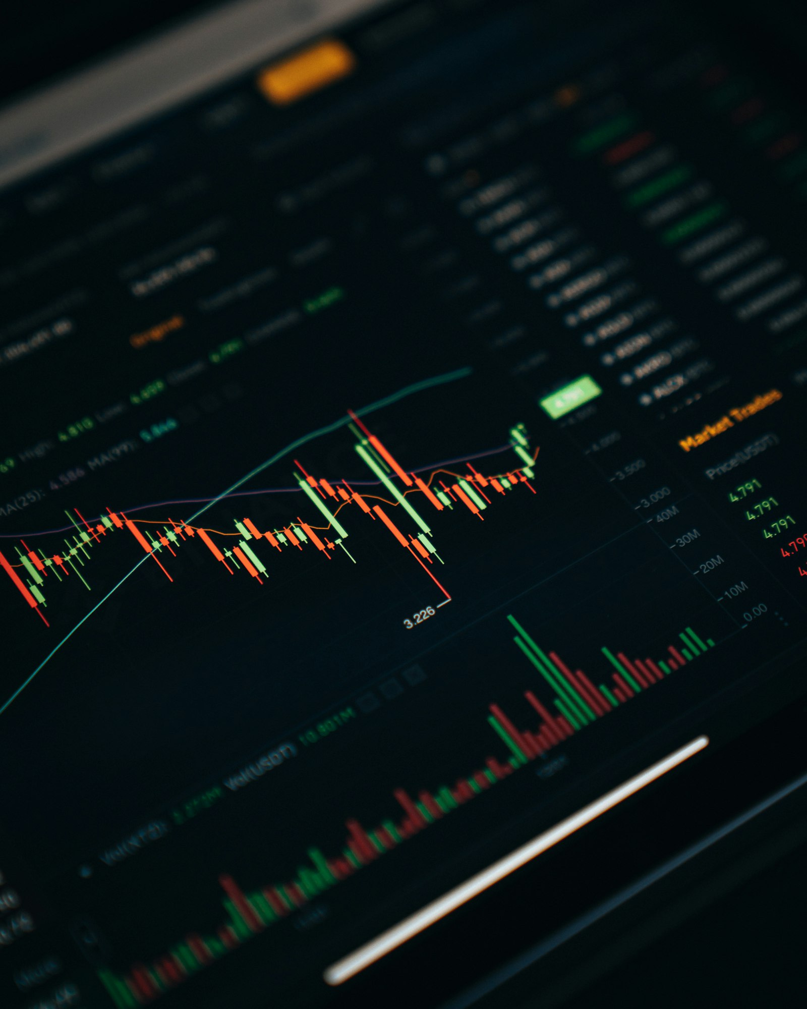 Cryptocurrency coins and trading charts on a screen