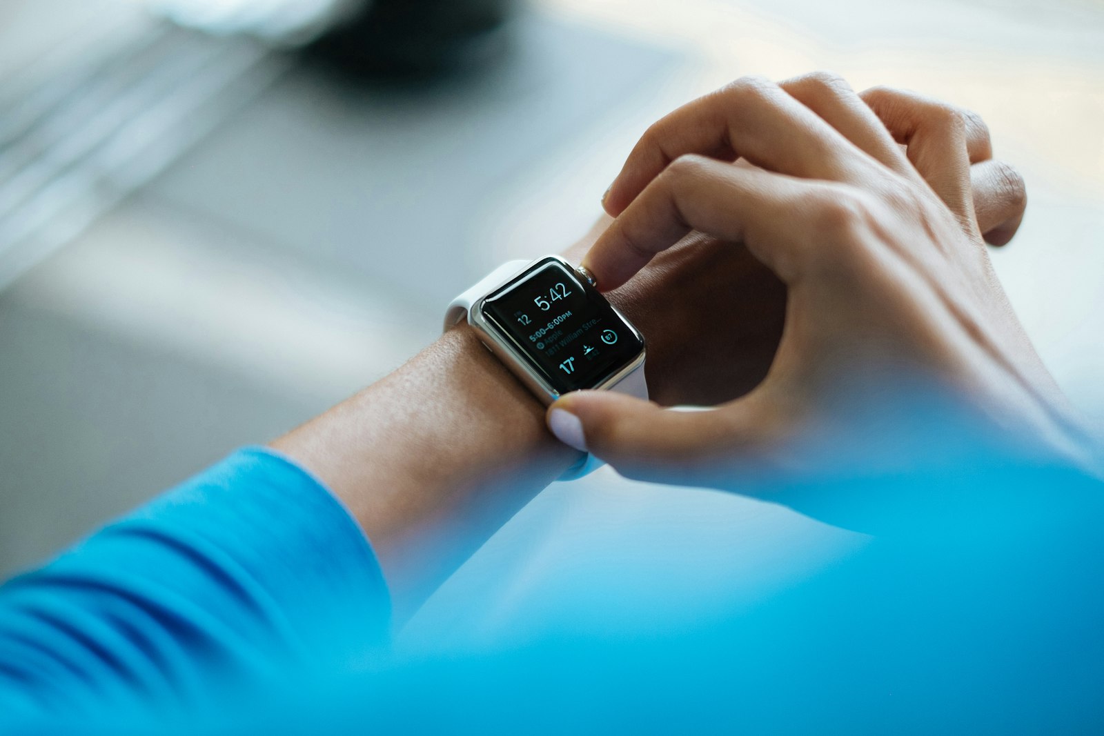 Person checking a smartwatch while outdoors