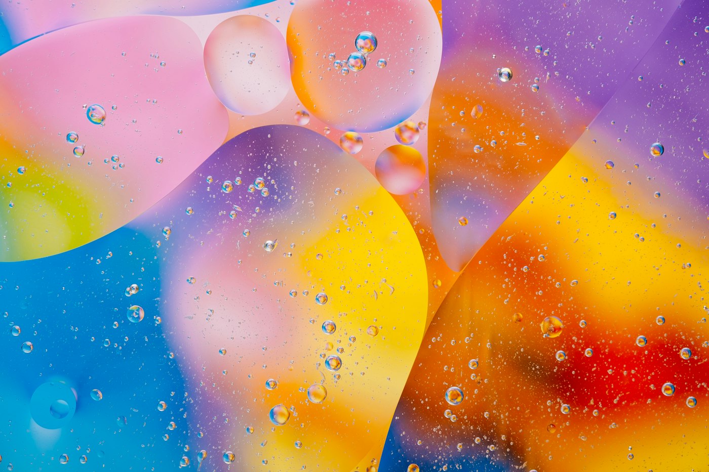 Abstract colorful oil droplets in water forming overlapping translucent spheres