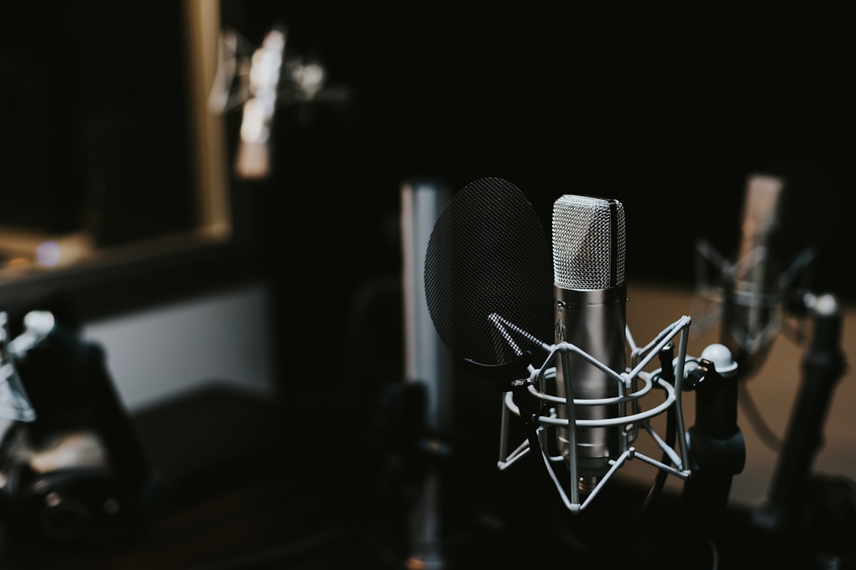 Close-up of a studio microphone against a dark background