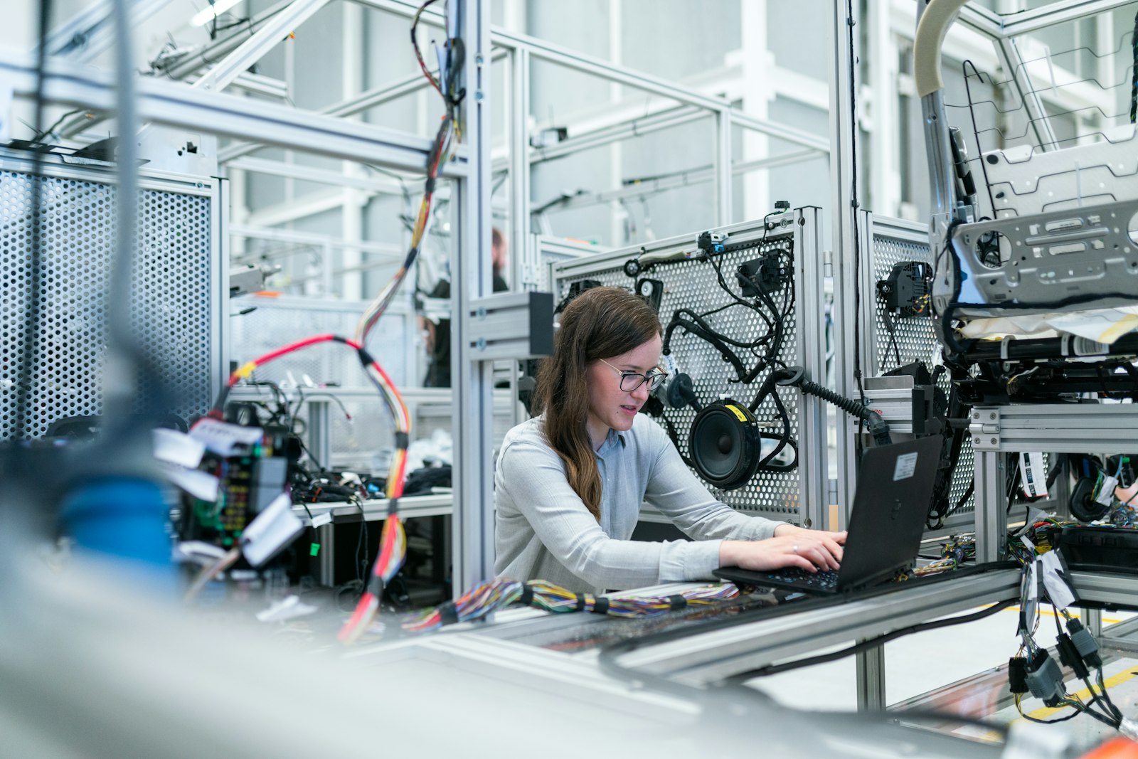 Engineer working with electronics and a laptop in a lab