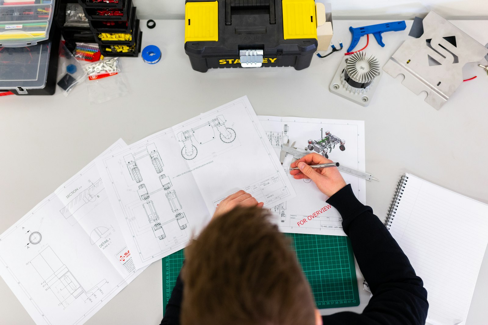 Technician assembling electronics at a workbench