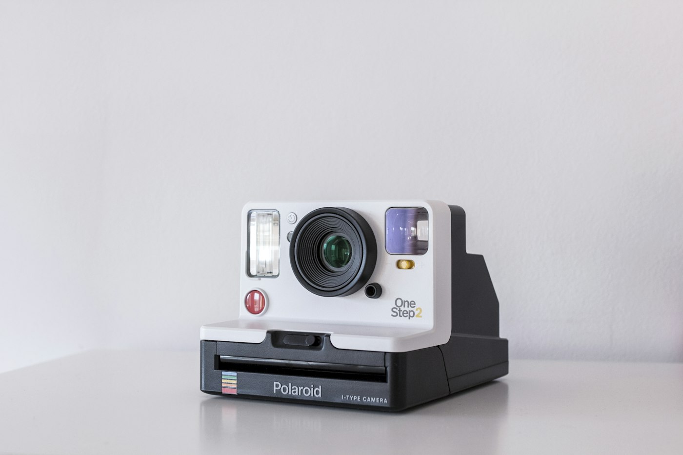 Retail display of a camera and folded clothes on a wood table