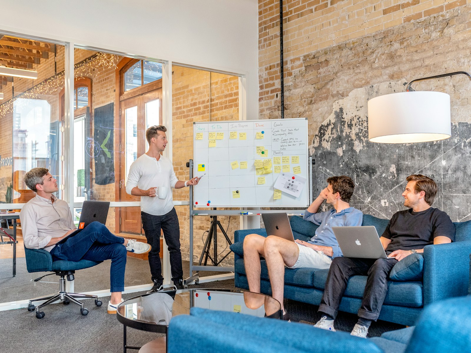 Team collaborating around a laptop in a modern office
