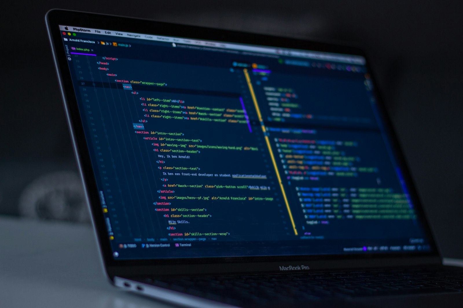 MacBook Pro screen showing syntax-highlighted code in a dark IDE