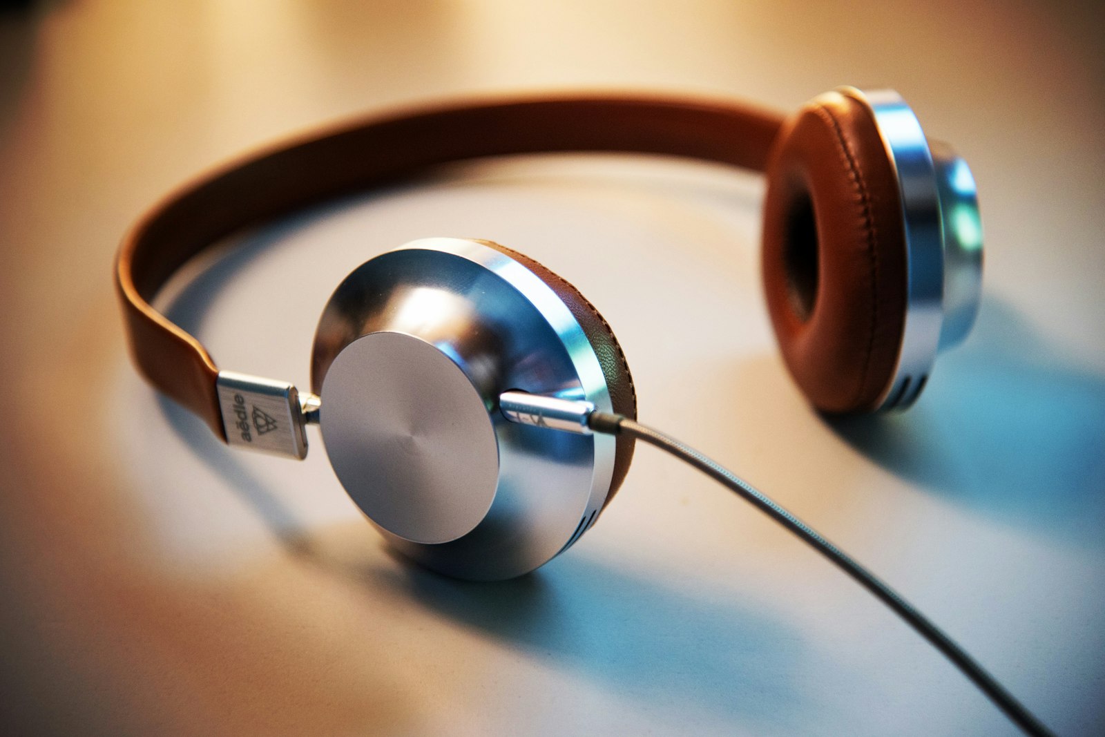 White over-ear headphones on a wooden desk