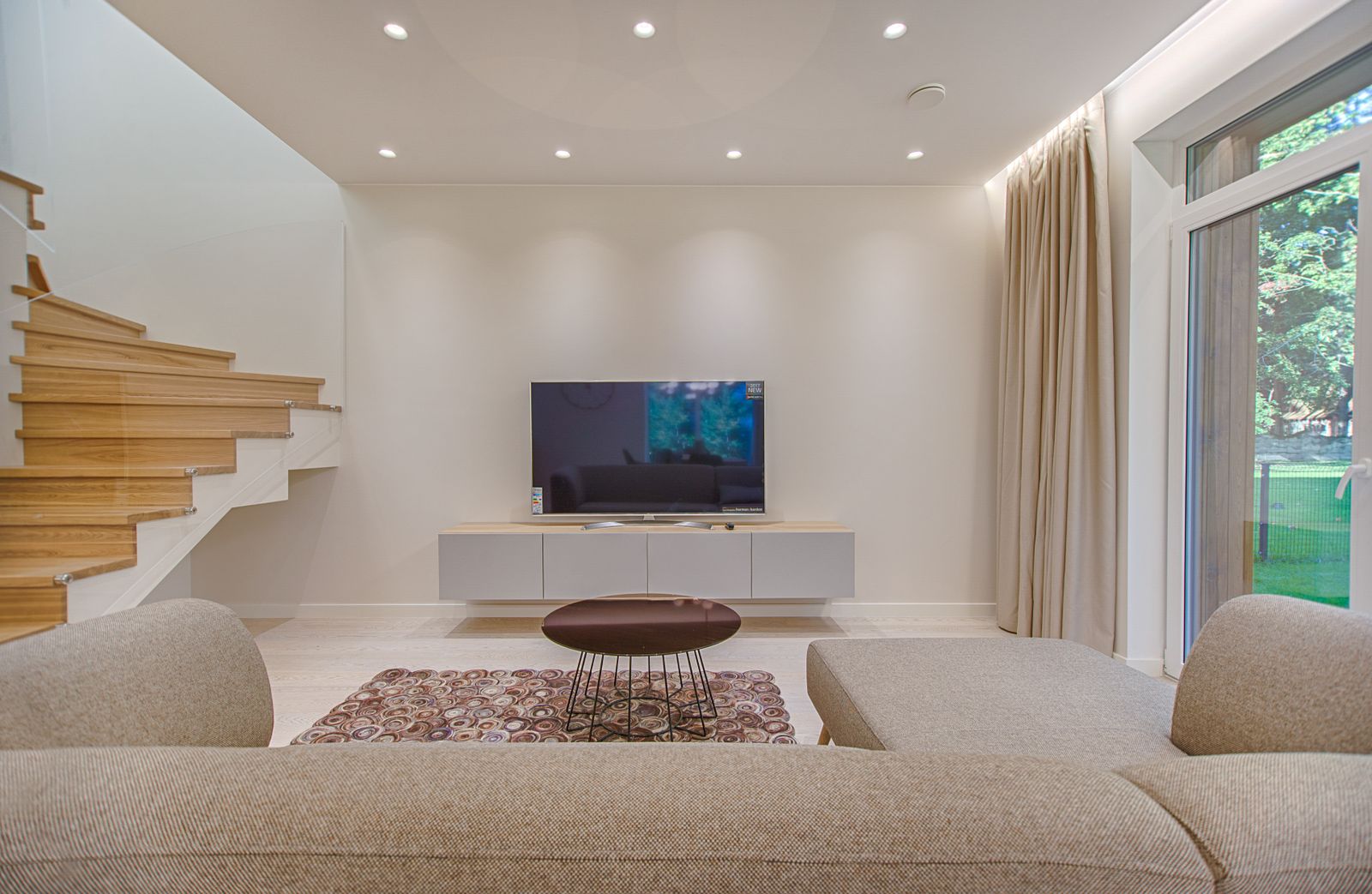 Modern living room with a large television on a media console