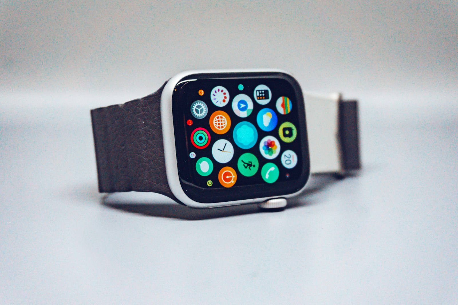 Smartwatch with a round colorful watch face on a person's wrist