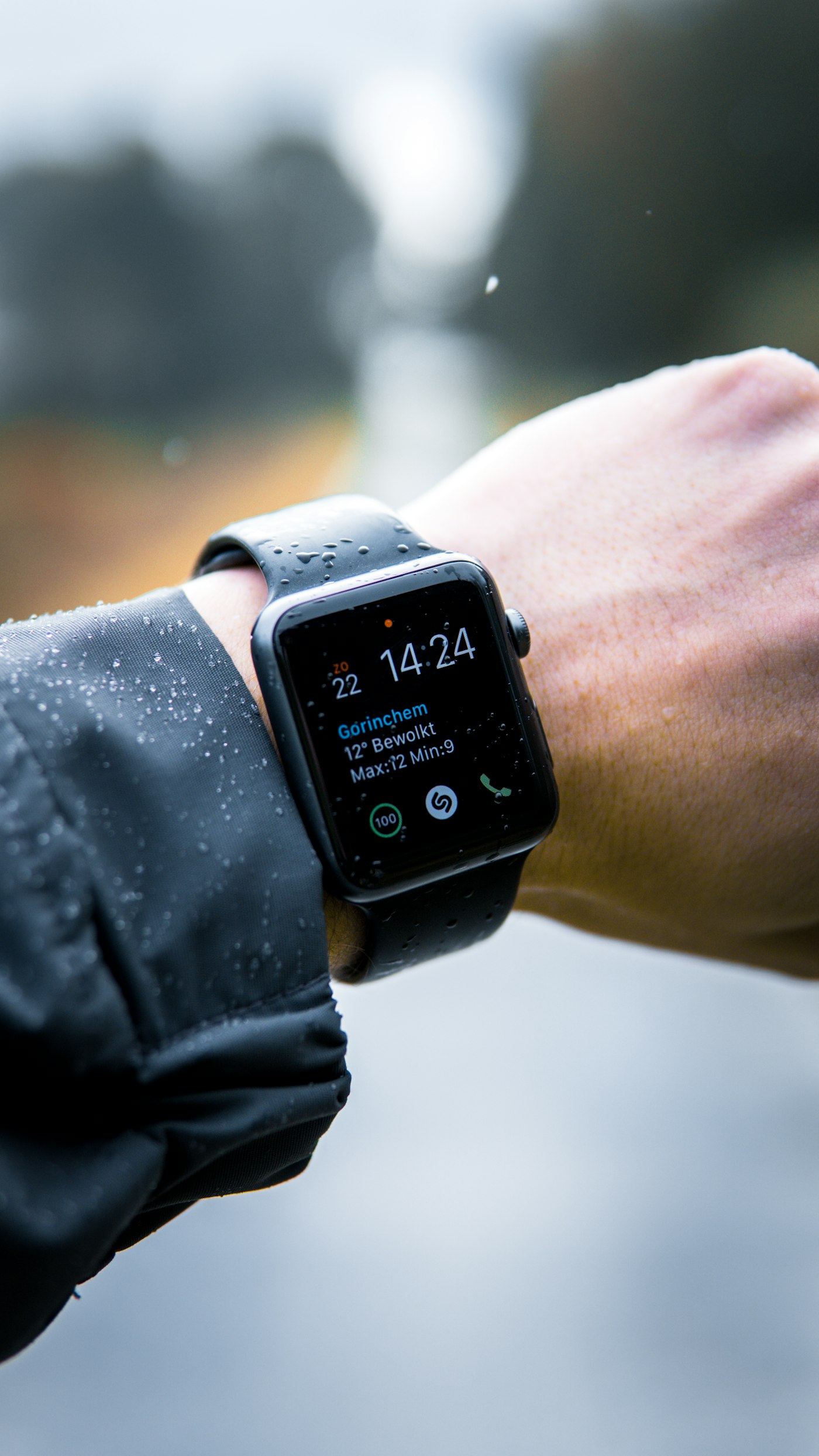 Close-up of a smartwatch worn on a wrist outdoors