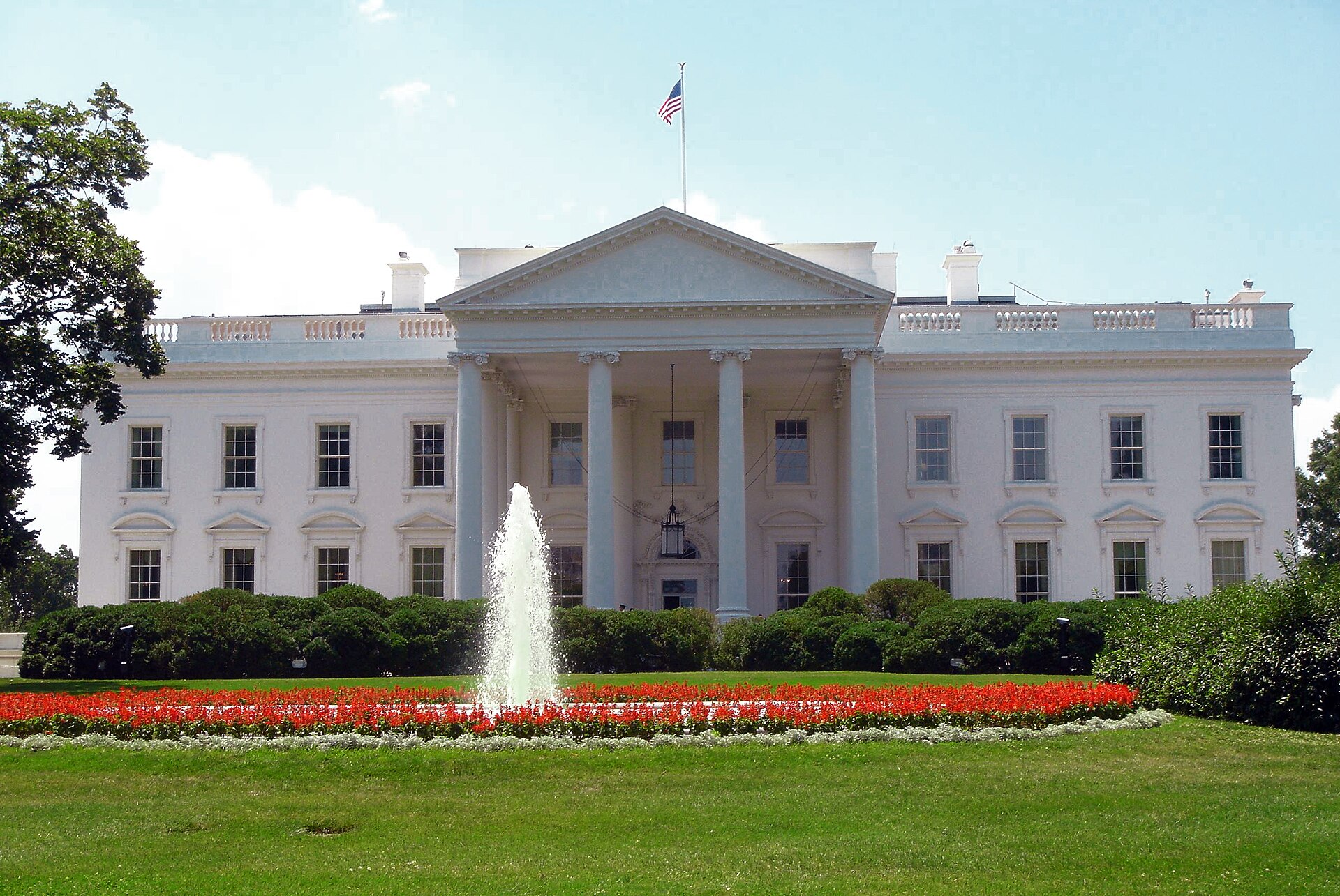 The north facade of the White House with its fountain and red flower beds
