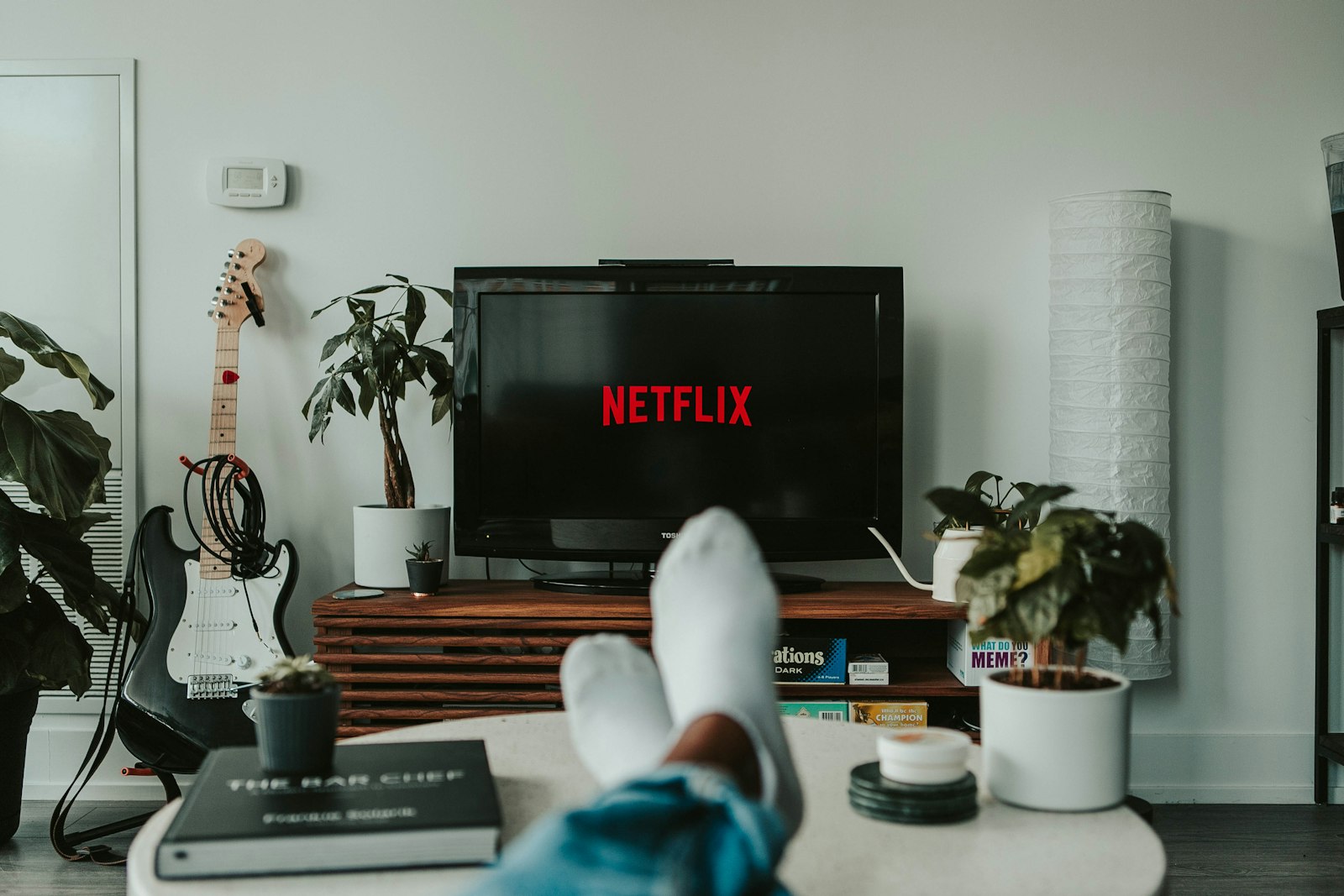 Person watching television on a couch in a living room