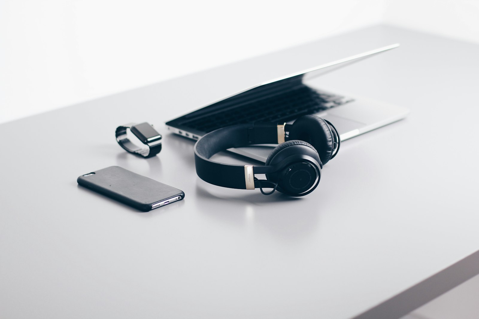 Desk scattered with gadgets, headphones, and tech accessories