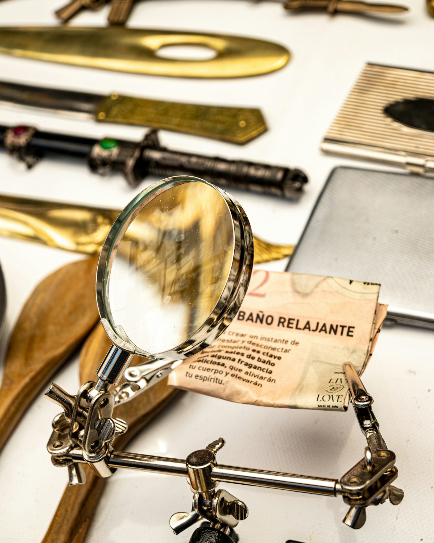 Magnifying glass on a helping-hands stand held over a small printed paper label