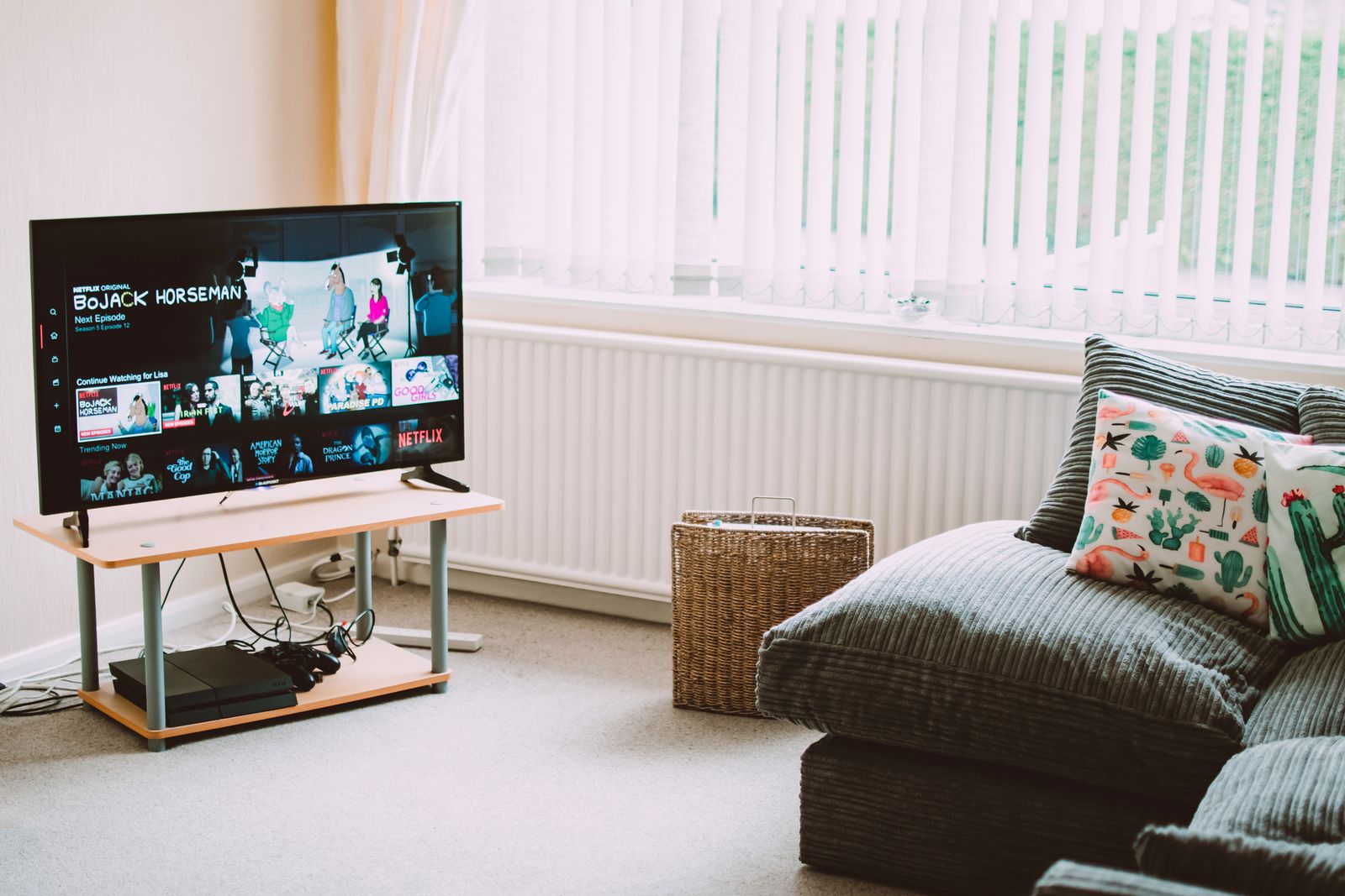 Living room television on a stand showing a streaming home screen