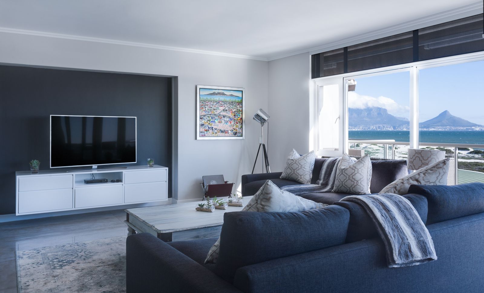 Modern living room with a large flat-screen TV and sectional sofa