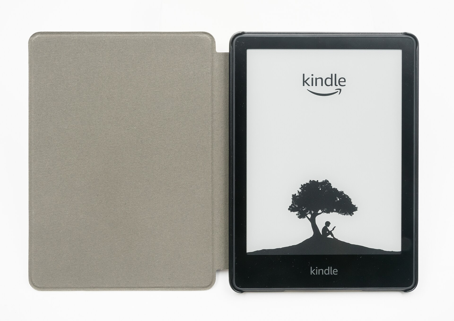 An Amazon Kindle Paperwhite e-reader in an open gray cover showing the Kindle start screen