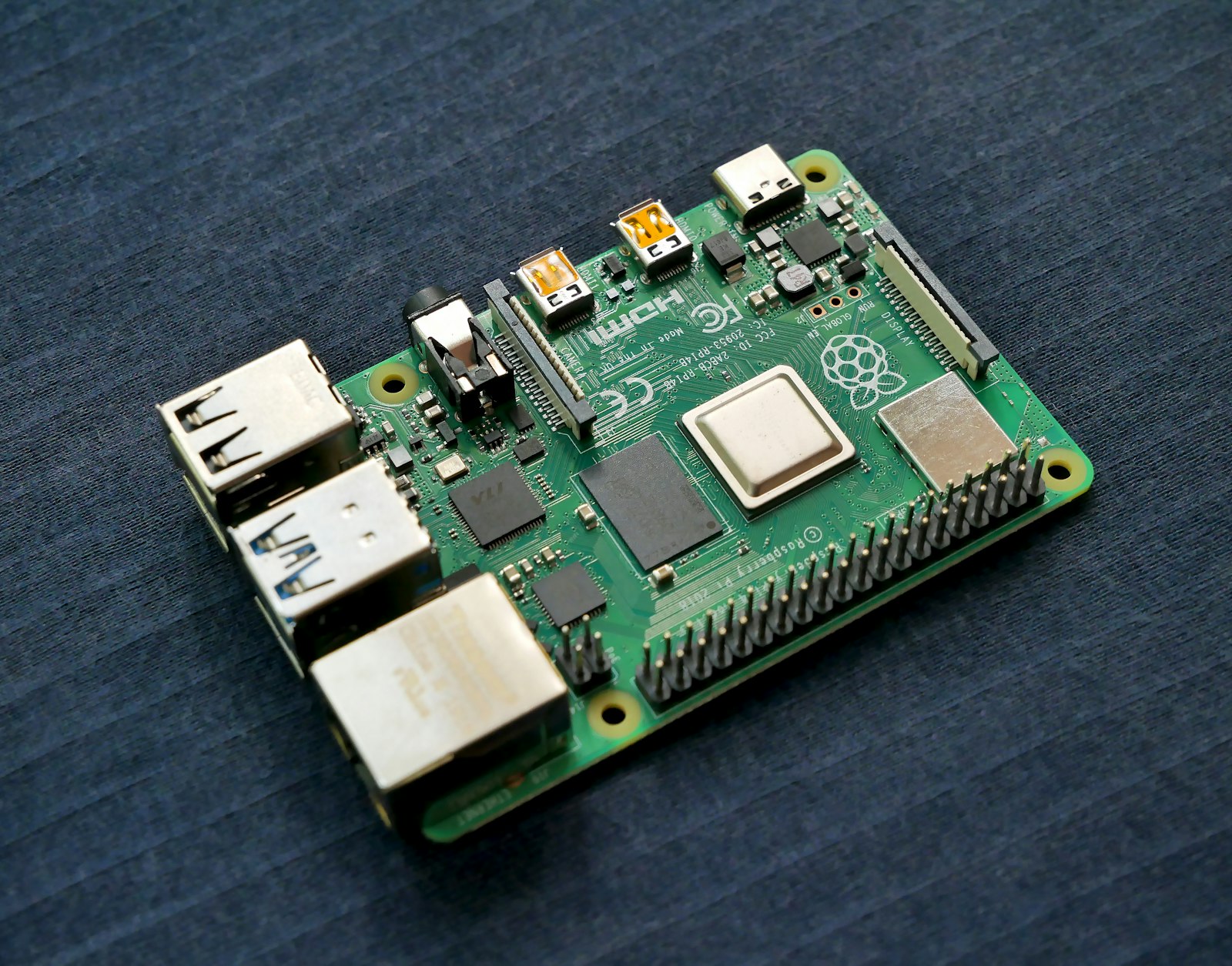Green circuit board with chips and solder pads in close-up