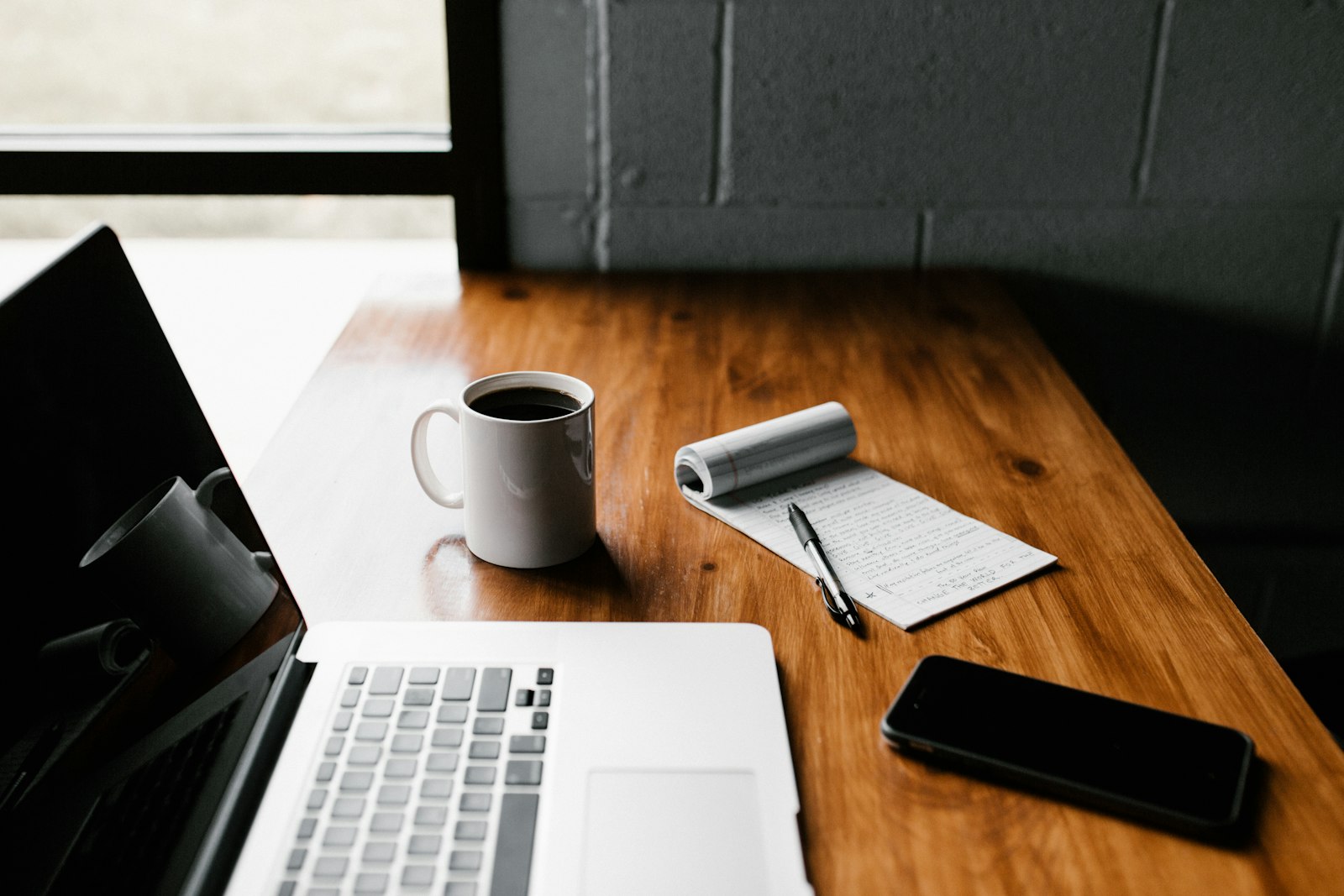 Laptop and coffee on a wooden desk for focused work