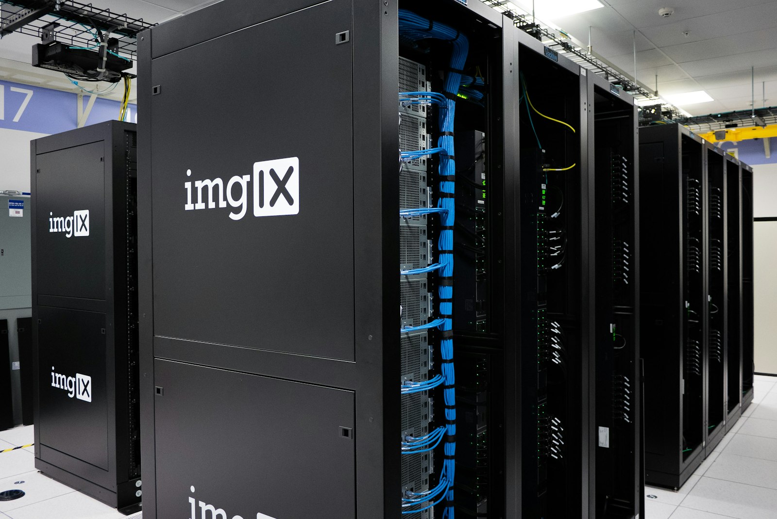 Rows of black server systems in a data center aisle