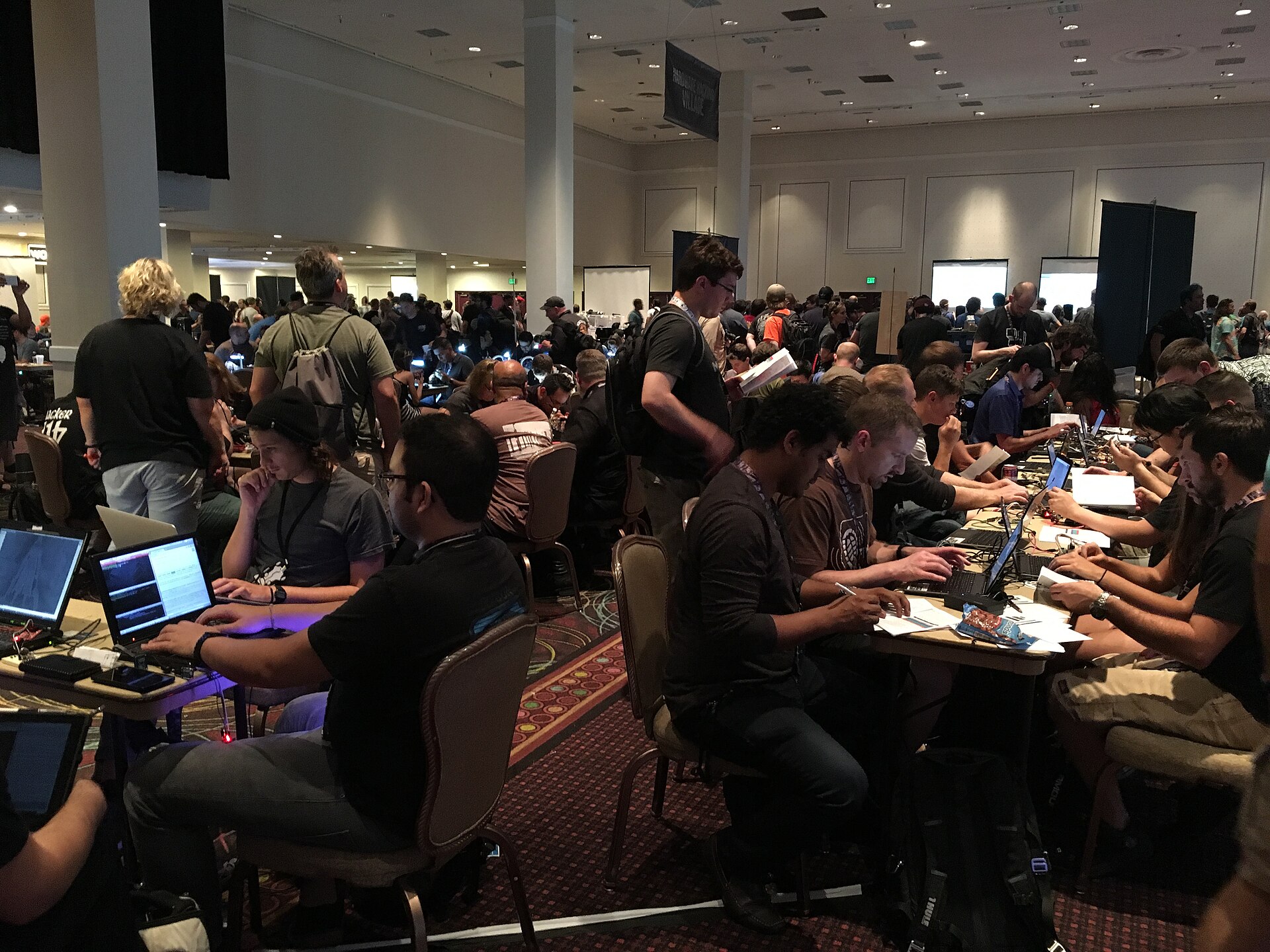 Rows of people working on laptops in the contest area at the DEF CON 24 security conference